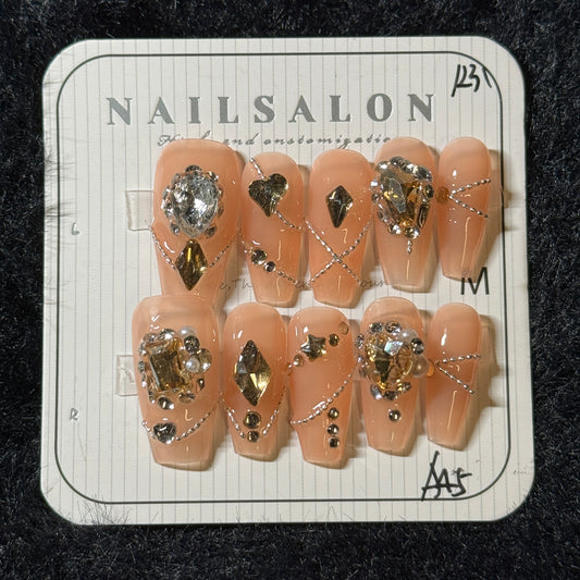 press-on nails / orange pink with stones and chains