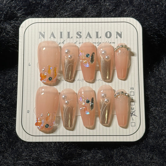 press-on nails / orange-pink golden with colorful stones and pearls