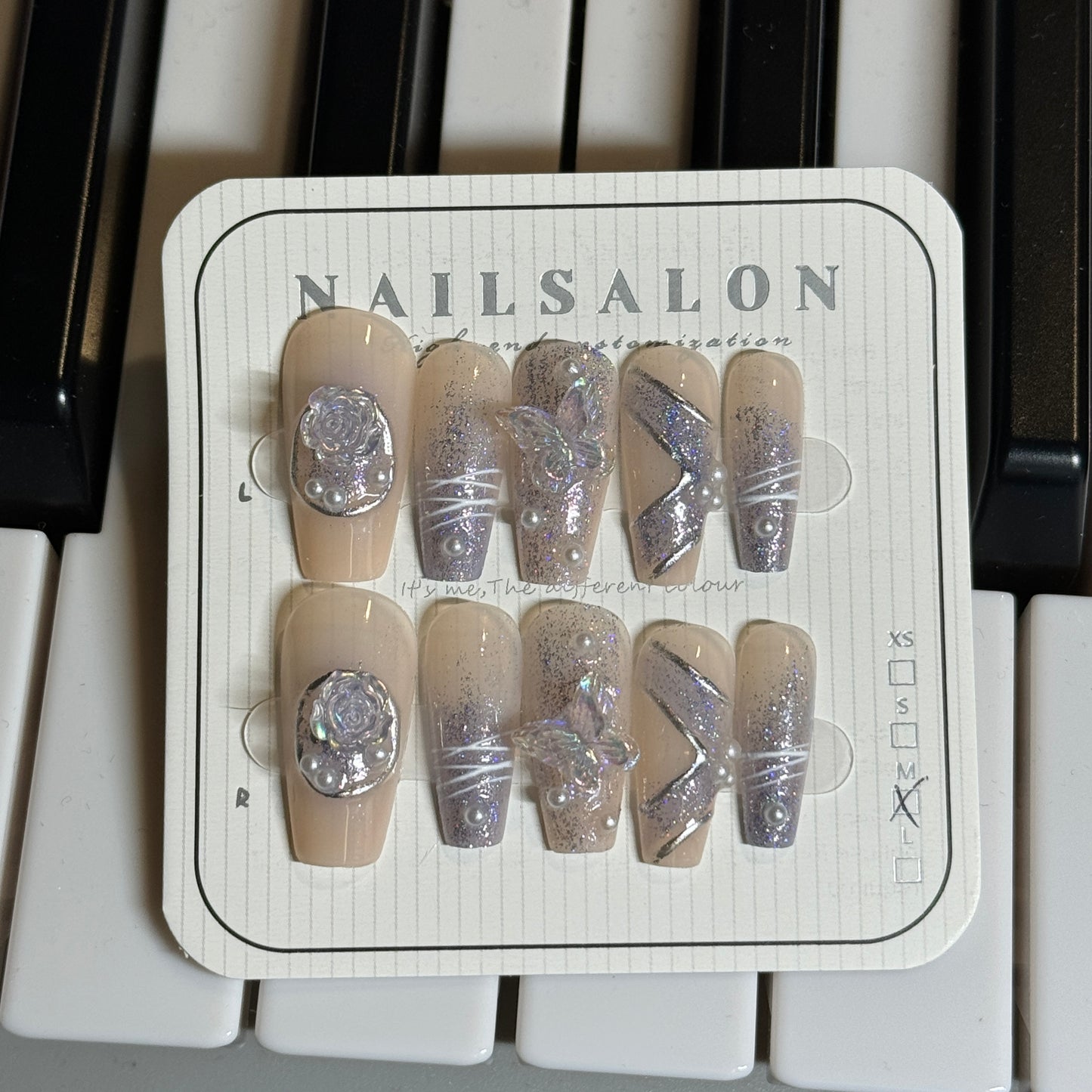 press-on nails / nude color w purple pattern and pearls